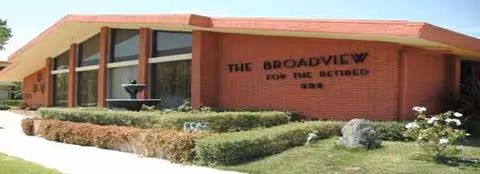 Brick exterior of Broadview Residential Care Center with a small fountain and shrubs