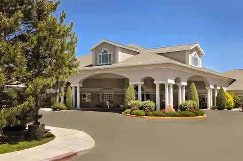 Front exterior of Life Care Center of Treasure Valley with a covered entrance and landscaping.