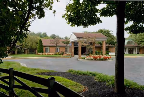 Exterior view of Future Care Chesapeake facility with entrance, circular driveway, and landscaped garden.