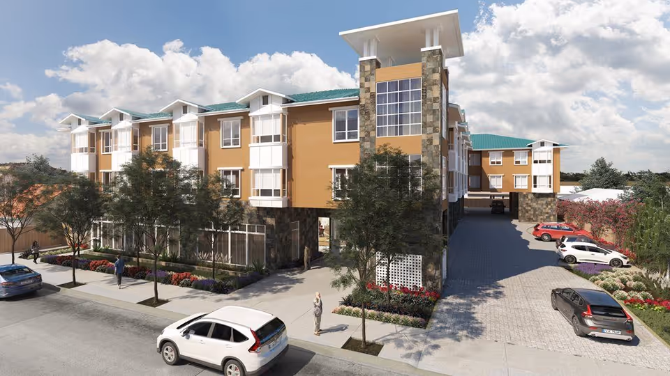 Exterior view of a three-story senior living building with landscaped sidewalk, parked cars, and people.