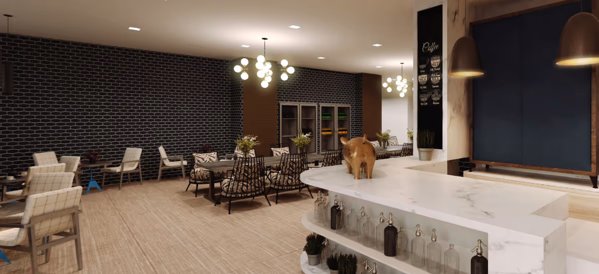 Modern communal dining and lounge area with a marble service counter, tables and chairs, pendant lighting and decorative shelving.