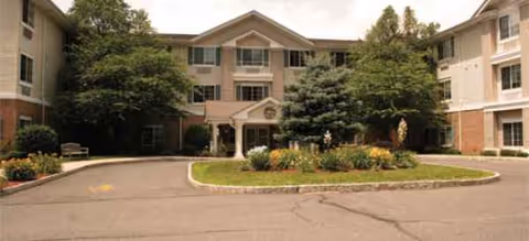Front view of Brookdale Wayne senior living building with a circular driveway and landscaping.