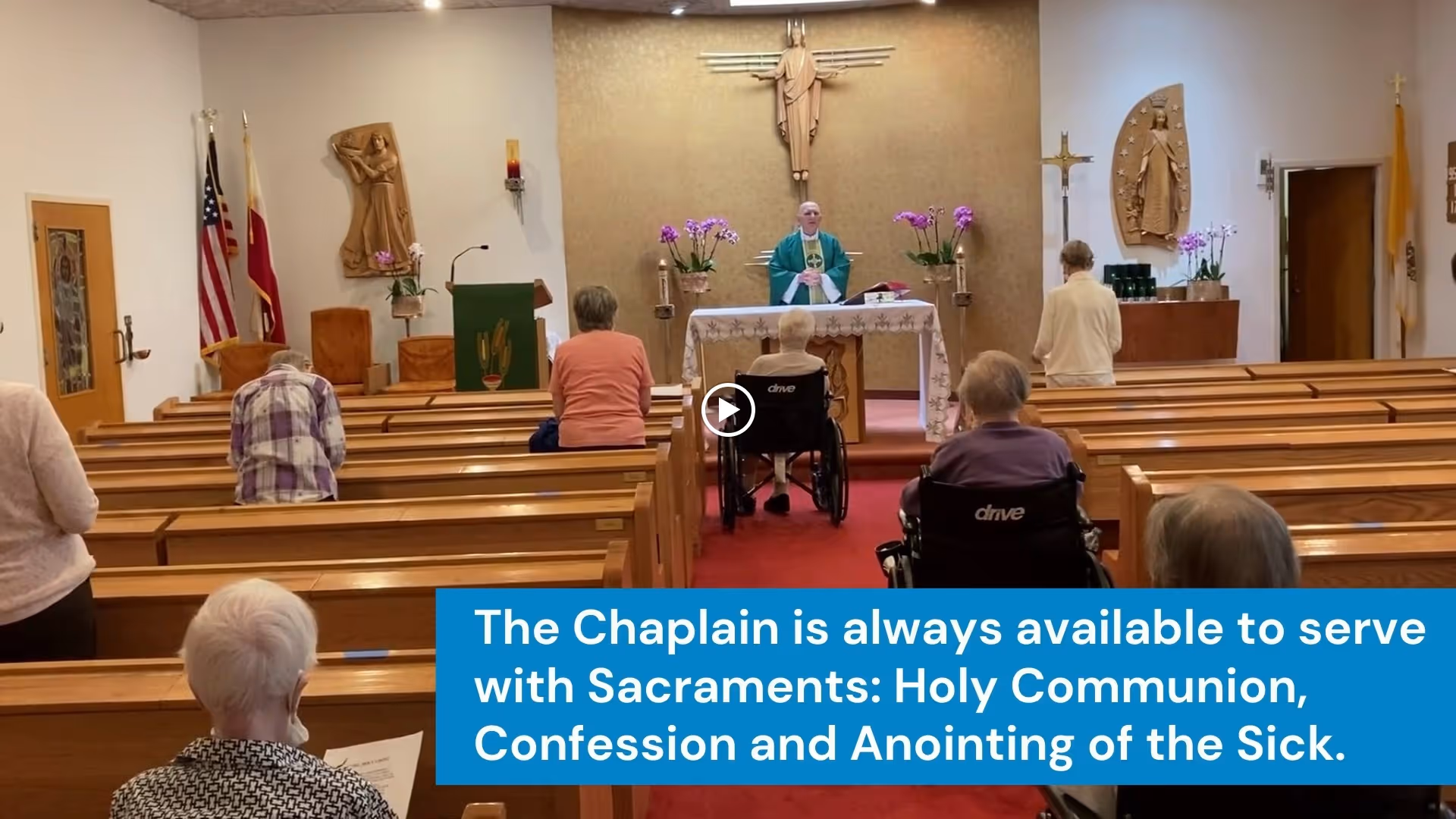 Interior of a chapel with elderly people seated in wooden pews, some in wheelchairs, facing a chaplain standing behind an altar. Religious symbols and decorations are visible on the walls, including a crucifix and statues. A text overlay states that the chaplain is available to serve with sacraments such as Holy Communion, Confession, and Anointing of the Sick.