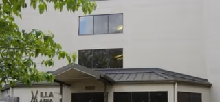 Front exterior of Villa Maria senior living facility with a covered entrance and large windows.