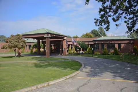 Front view of Pennsylvania Soldiers' and Sailors' Home with a covered entrance and flags.