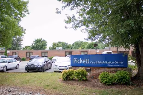 Exterior view of Pickett Care and Rehabilitation Center with parked cars.