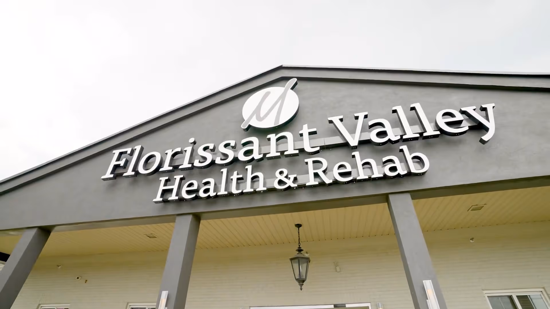 Front facade of Florissant Valley Health & Rehab with large raised signage above the entrance.