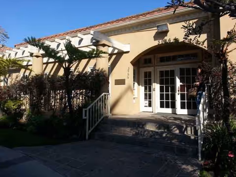 Entrance of Mar Vista Healthcare and Wellness Centre, beige exterior with glass doors, stairs, and landscaping.