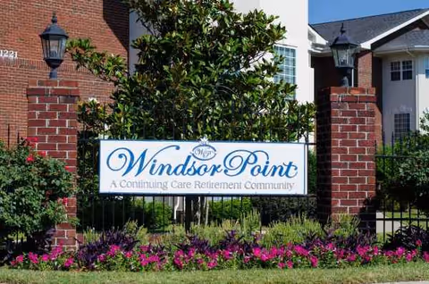 Entrance sign Windsor Point with brick columns and manicured landscaping.