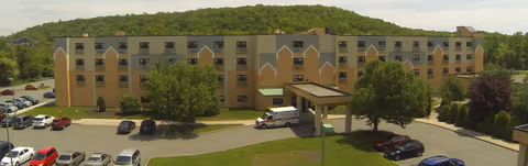 Exterior view of The Wanaque Center for Nursing & Rehabilitation with a covered entrance.