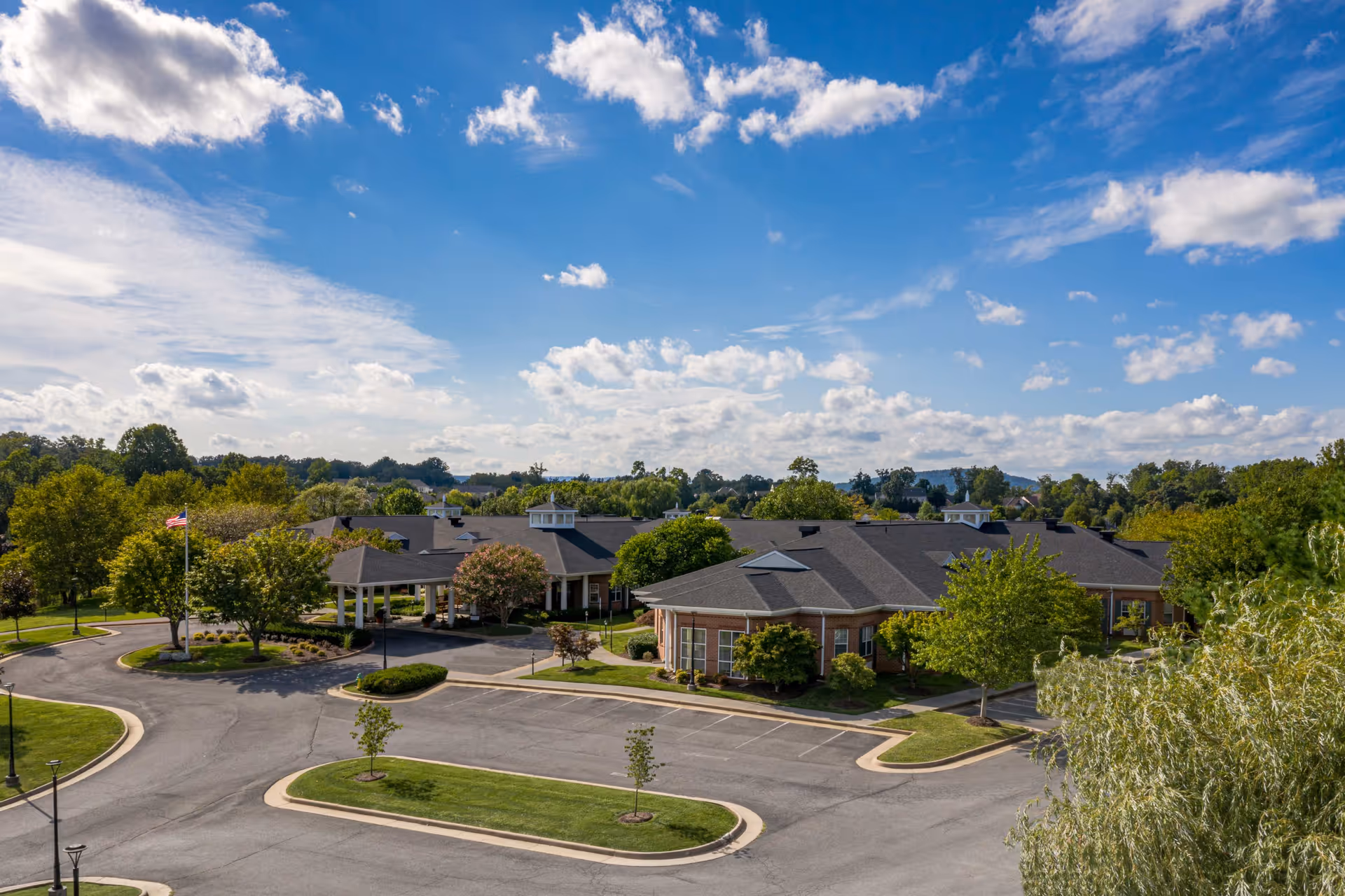 Aerial view of The Willows At Meadow Branch, showing brick buildings, circular drive, and landscaped grounds.