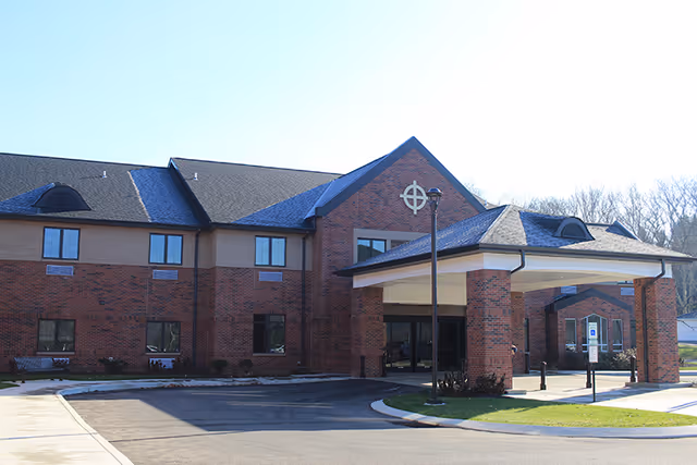 Exterior view of Concordia at Villa St. Joseph, a brick senior living facility with a covered entrance.