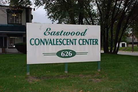 Eastwood Convalescent Center sign on a grassy lawn with trees in background