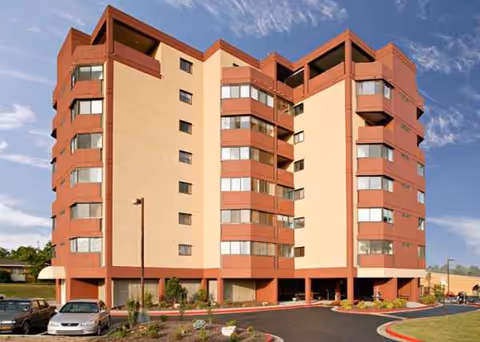 Cornerstone Village senior living building with a parking lot and landscaped entrance.