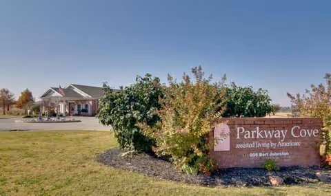 Exterior view of Parkway Cove assisted living facility with sign and entrance.
