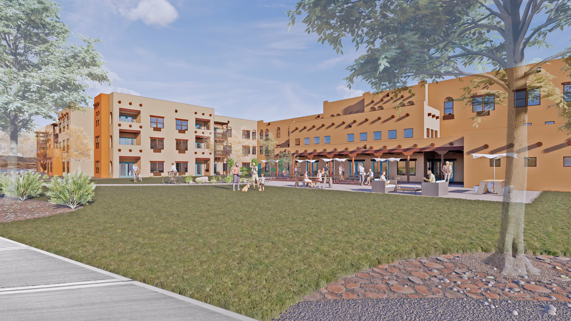 Outdoor view of Ativo Senior Living of Albuquerque featuring a large grassy area with trees and shrubs, a patio with tables, chairs, and umbrellas, and a multi-story building with southwestern architectural style in the background. Several people are seen walking, sitting, and engaging in activities on the lawn and patio.
