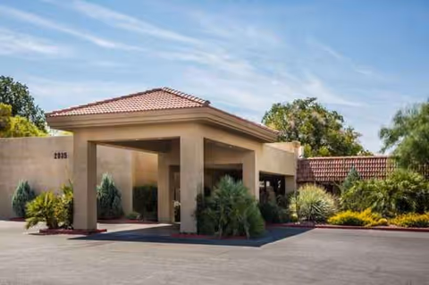 Front entrance of St. Joseph Transitional Rehabilitation Center, beige stucco building with a tiled roof.