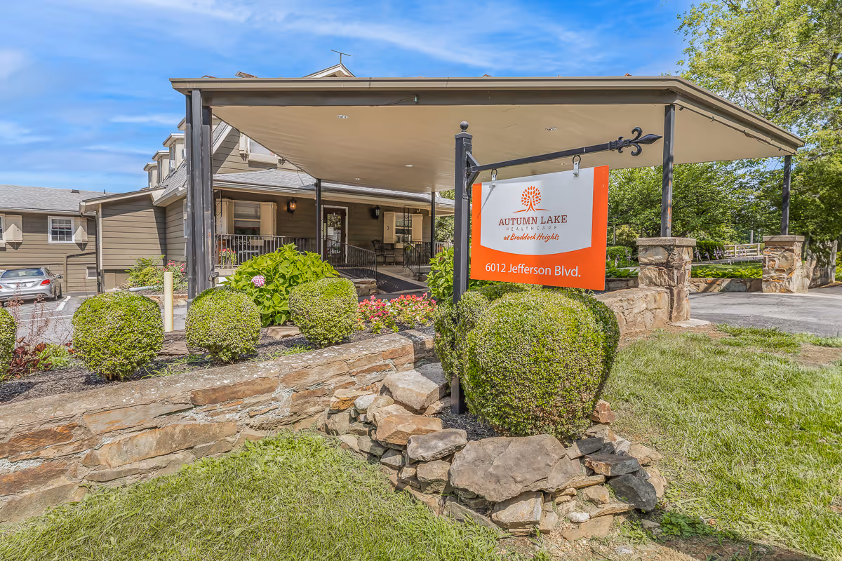 Front entrance of Autumn Lake Healthcare at Braddock Heights with a covered driveway, landscaping, and a sign reading 6012 Jefferson Blvd.
