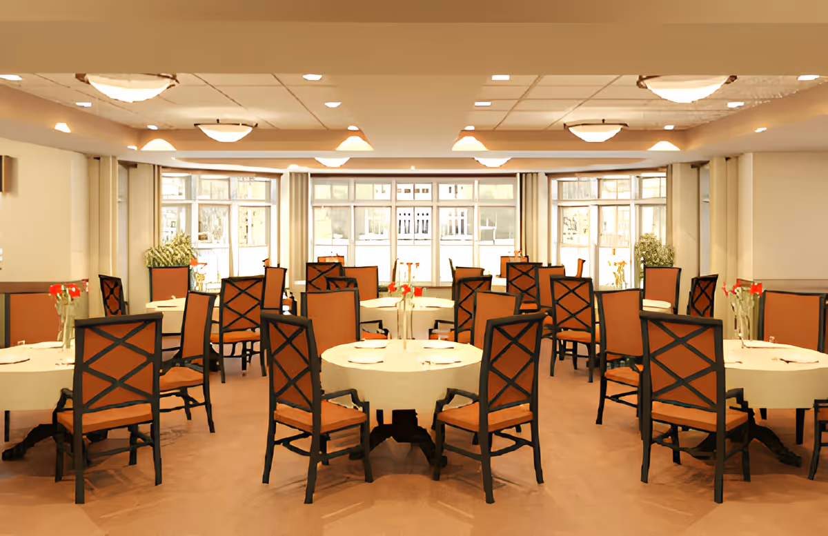 Dining room with round tables and orange-upholstered chairs arranged for meals.