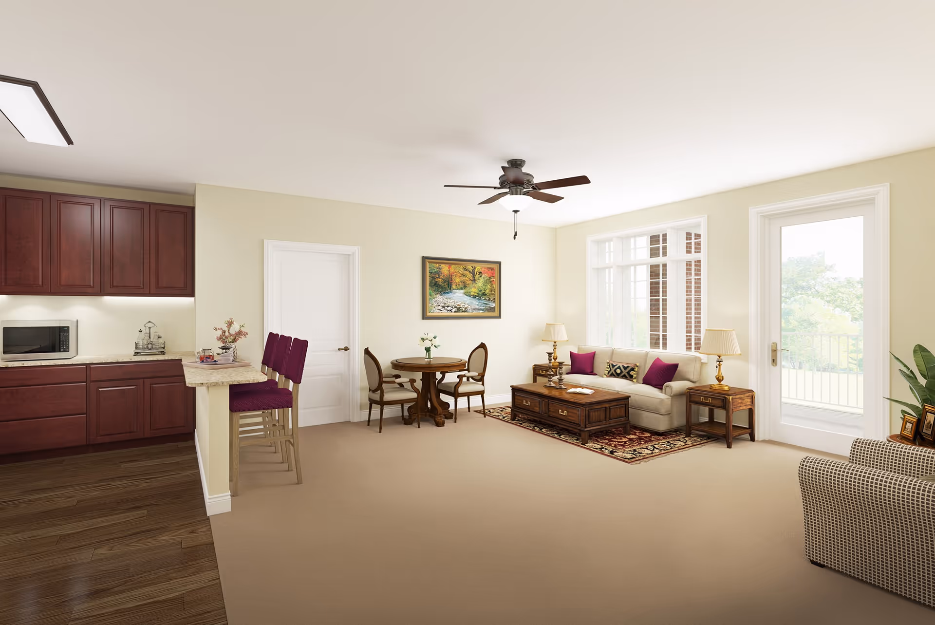 A bright and spacious living area with beige walls and carpet. The room features a beige sofa with purple and patterned cushions, a wooden coffee table on a decorative rug, two side tables with lamps, and a round wooden dining table with two chairs. To the left is a kitchen area with dark wood cabinets, a microwave, and a countertop with three purple bar stools. A ceiling fan is mounted in the center of the ceiling, and large windows and a glass door provide natural light and a view of greenery outside.