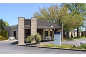 Front view of Chambersburg Skilled Nursing and Rehabilitation Center with entrance canopy and sign.