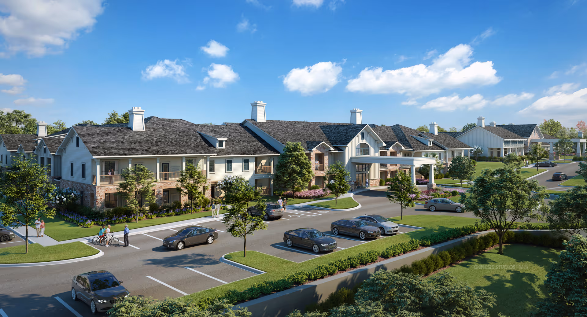 Exterior view of a senior living facility with multiple two-story buildings featuring balconies, surrounded by landscaped greenery and parking spaces with several cars. People are walking and biking along the sidewalks under a partly cloudy blue sky.