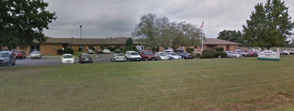 Exterior view of Waverly Rehabilitation and Healthcare Center with cars parked in front