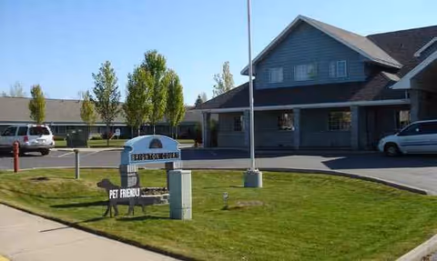 Exterior view of Brighton Court Assisted Living entrance with a pet-friendly sign and parking.