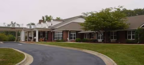 Exterior view of Fremont Rest Center, a single-story brick building with a curved driveway.