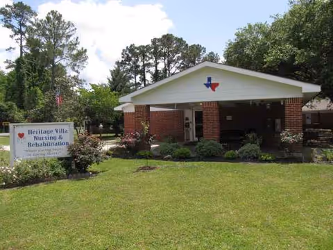 Front view of a brick nursing facility with a covered entrance and well-kept lawn.