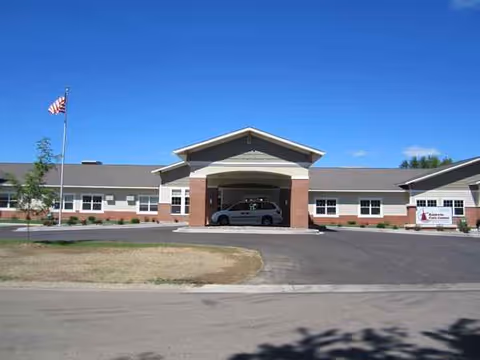 Front view of Baldwin Care Center with porte-cochère entrance and parked car.