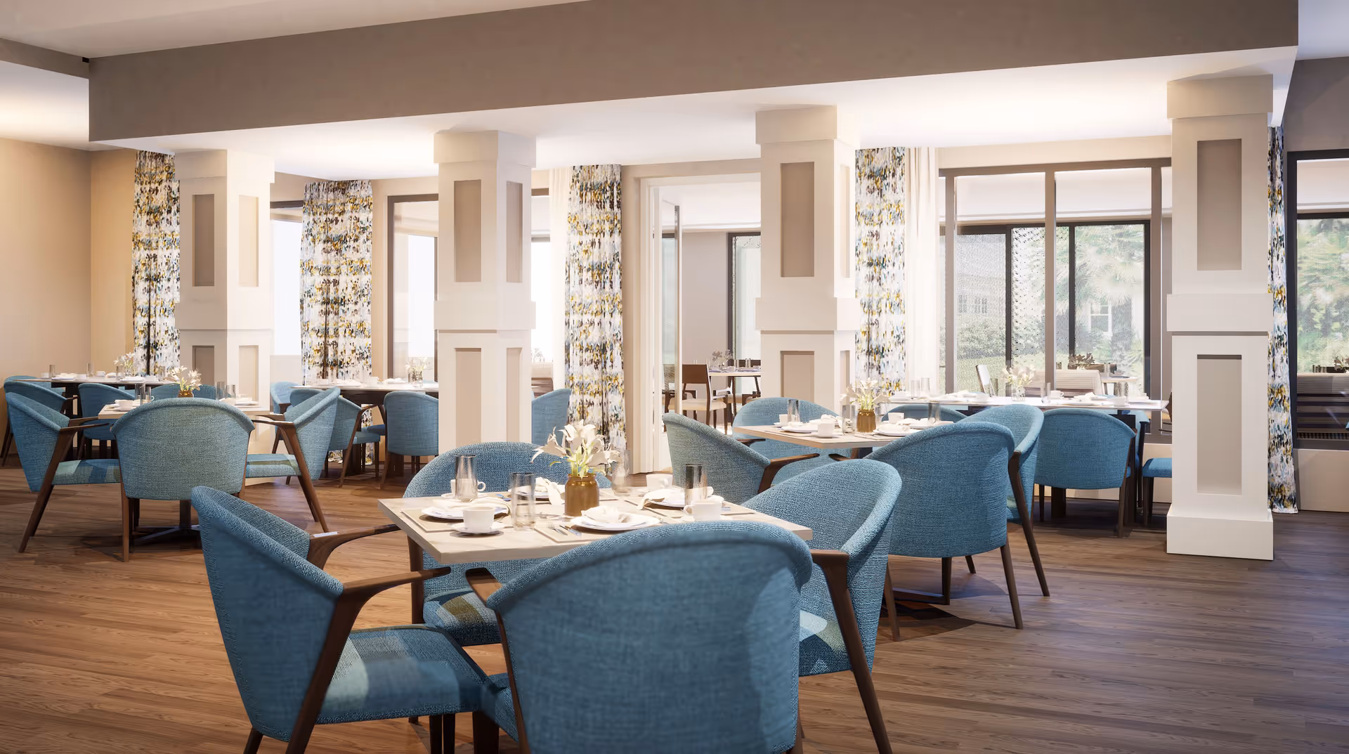 Bright dining room with multiple tables set for meals surrounded by blue upholstered chairs and decorative columns.