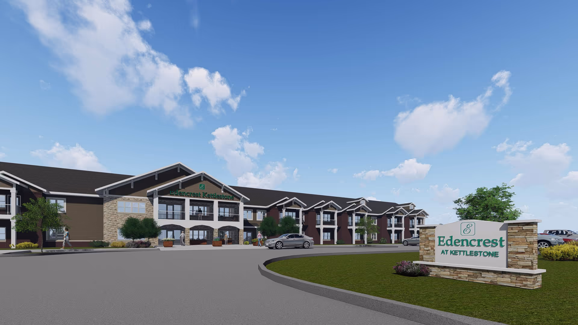 Exterior view of Edencrest at Kettlestone, a large senior living facility with a modern design featuring stone and siding, multiple windows, and a two-story structure. There are a few people walking near the entrance and cars parked nearby under a partly cloudy blue sky.
