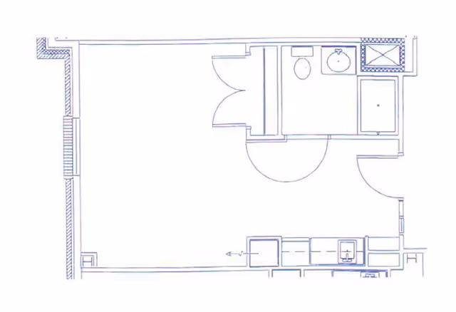 Architectural floor plan showing a small apartment or room layout with a bathroom including a toilet, sink, and shower, and a kitchenette area with a sink and cabinets.