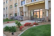 Heritage Manor Springfield exterior with outdoor seating and landscaped lawn.