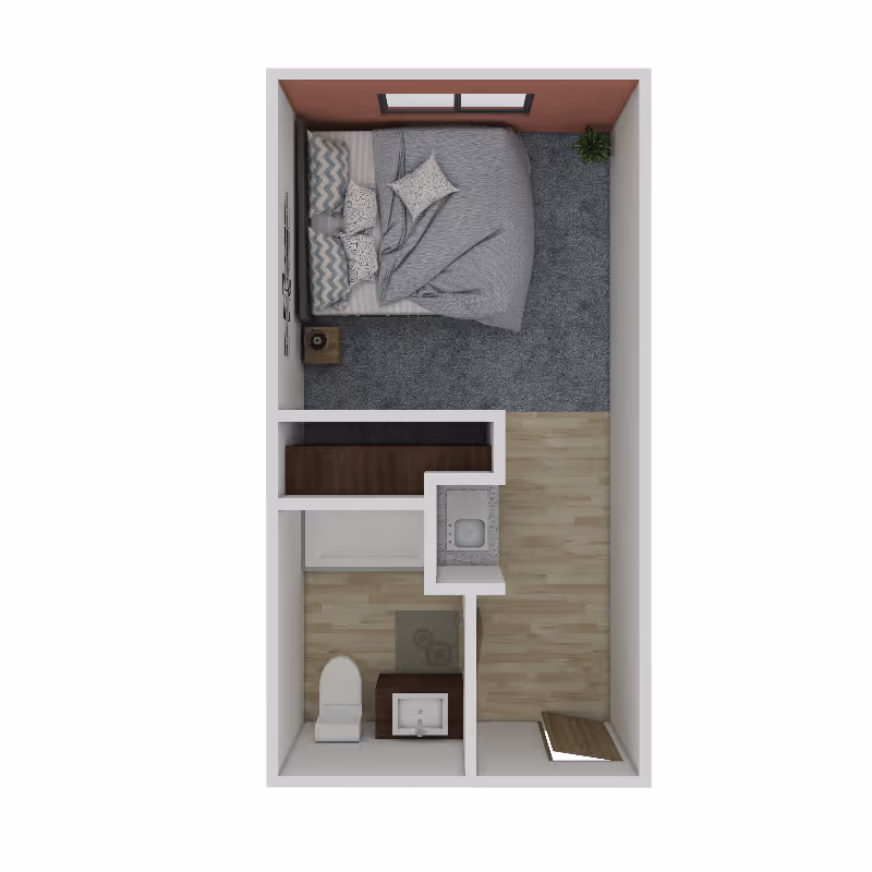 Top-down view of a small apartment floor plan featuring a bedroom with a bed, pillows, a nightstand, and a plant. Adjacent to the bedroom is a bathroom with a toilet, sink, and bathtub. The entryway has a small closet and wooden flooring throughout.