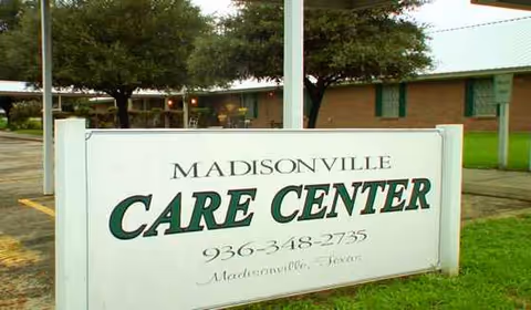 Outdoor view of Madisonville Care Center sign in front of the building.