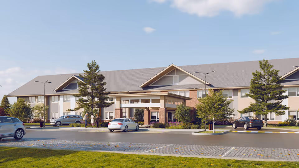 Exterior view of Alexi Senior Living facility showing a large two-story building with a covered entrance, several parked cars, trees, and a few people standing near the entrance under a partly cloudy sky.