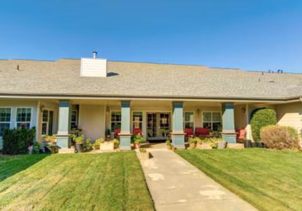 Front view of Mountain View Assisted Living and Memory Care building with walkway and porch.