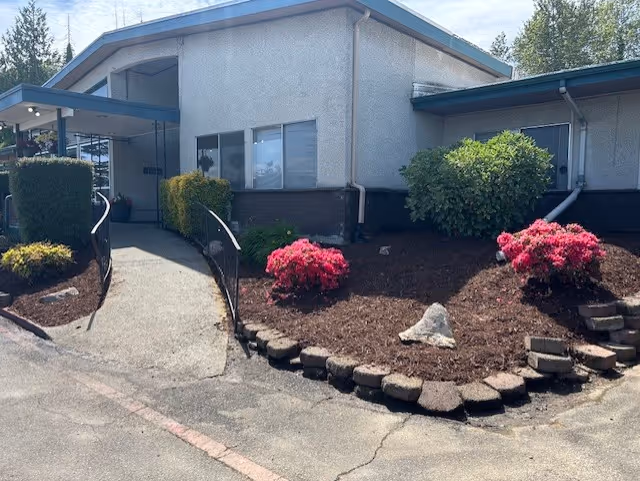 The exterior entrance of Renton Health and Rehabilitation featuring landscaped gardens and entryway.