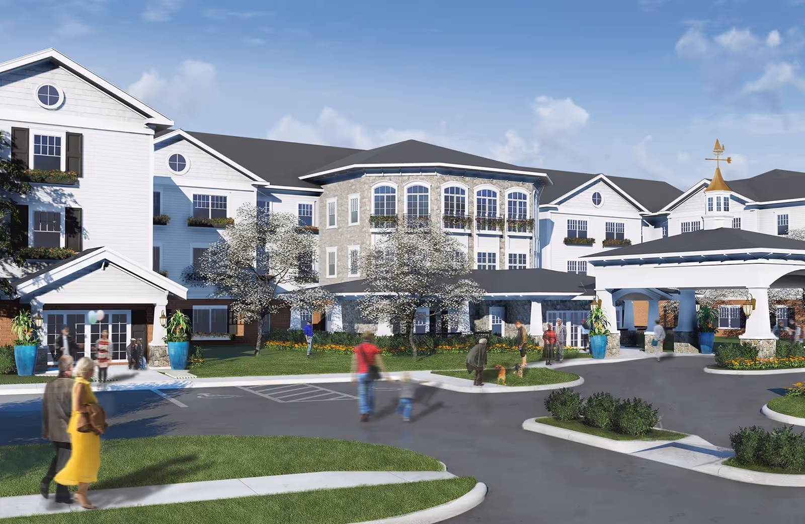 Exterior view of a senior living facility named American House Lakeshore, showing a large multi-story building with white siding, multiple windows with flower boxes, and a covered entrance. Several people are walking and standing outside on the driveway and sidewalks, with some greenery and trees around the building under a blue sky with scattered clouds.