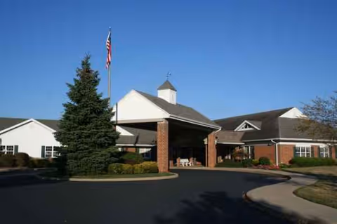 Sycamore Run Nursing and Rehabilitation Center exterior with brick entrance and flagpole.