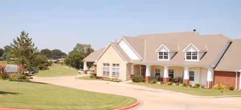Front exterior of Brookdale Bartlesville North senior living facility with driveway and manicured lawn
