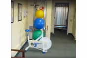 Indoor hallway with exercise equipment and colorful balls.