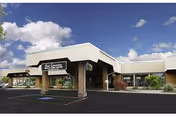 Exterior view of Good Samaritan Health Care Center building under a partly cloudy sky with a parking lot in front.