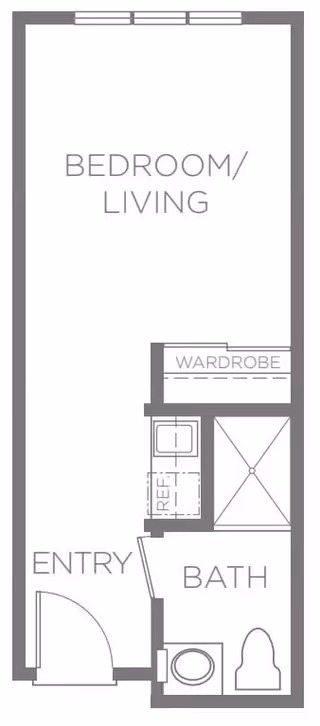 Architectural floor plan of a small living space labeled as Bedroom/Living area, with an entry door, a bathroom including a toilet and shower, a wardrobe, and a small kitchenette area with a sink and refrigerator.