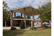 Exterior view of Grandview Nursing Home entrance with brick columns and landscaped grounds.