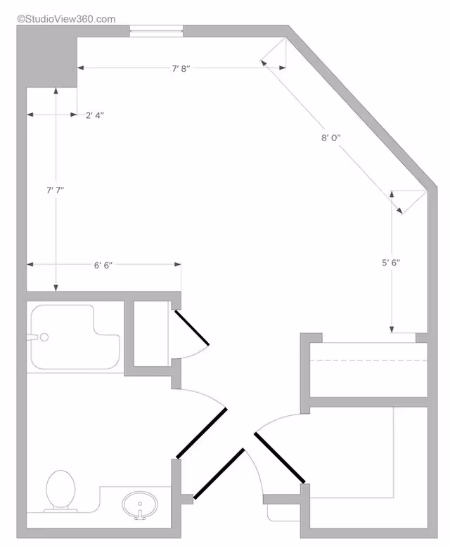Architectural floor plan of a small apartment or room layout showing dimensions, a bathroom with a bathtub, toilet, and sink, and a main living area with angled walls.