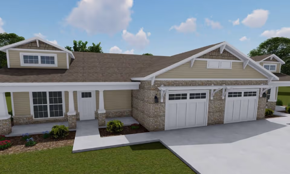 Exterior view of a single-story residential building with beige siding, stone accents, and a brown shingled roof. The building features a covered front porch with white columns, two garage doors, and landscaped areas with small bushes and flowers. The sky is blue with some clouds.