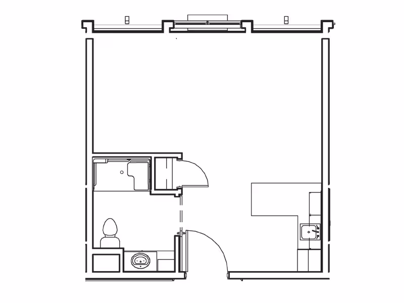 Architectural floor plan of a small living space including a bathroom with a toilet and shower, and a kitchenette area with a sink.